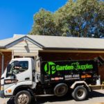 Image of JP Garden Supplies truck at a window counter