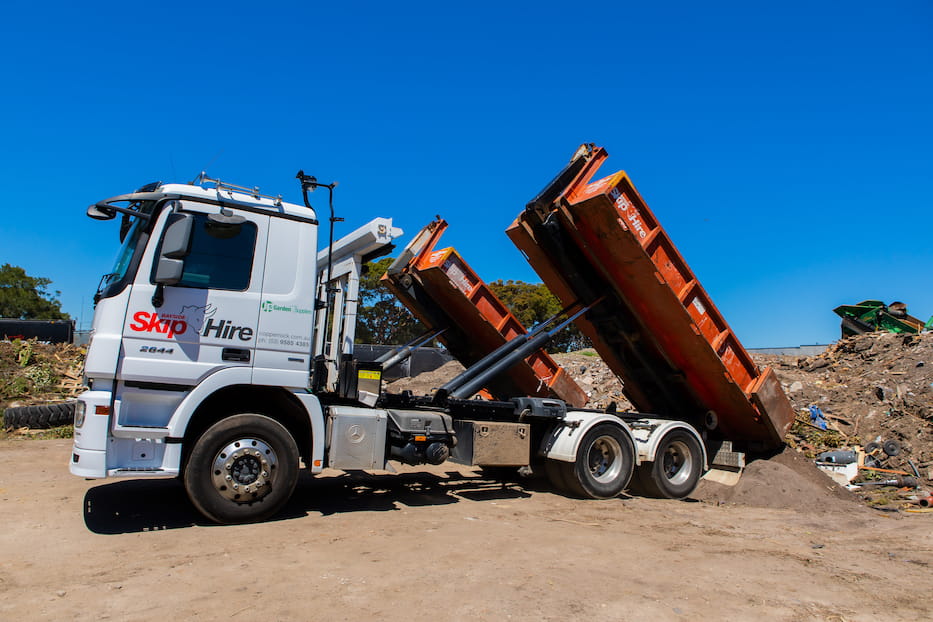 bayside Skip Hire truck tipping load into a dump site